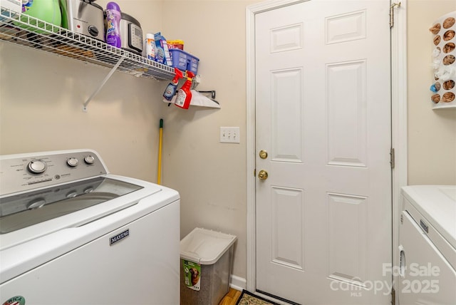 clothes washing area with washing machine and clothes dryer