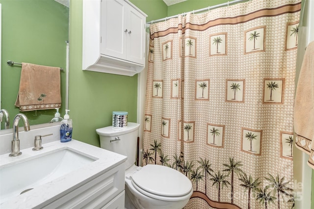 bathroom with walk in shower, vanity, and toilet