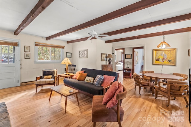 living room featuring light wood-style floors, beam ceiling, a baseboard heating unit, and ceiling fan