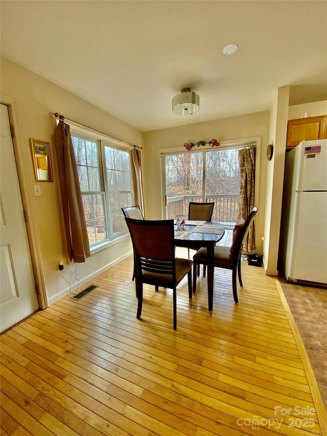 dining area with light hardwood / wood-style floors