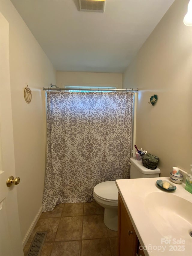 bathroom with lofted ceiling, vanity, toilet, and tile patterned flooring