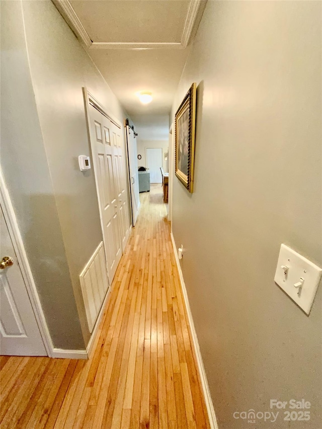 corridor with light hardwood / wood-style flooring