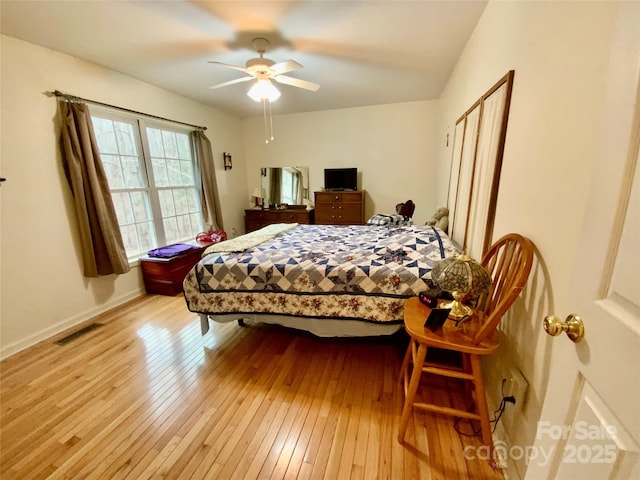 bedroom with ceiling fan and light hardwood / wood-style floors