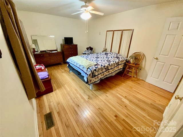 bedroom with ceiling fan and light wood-type flooring