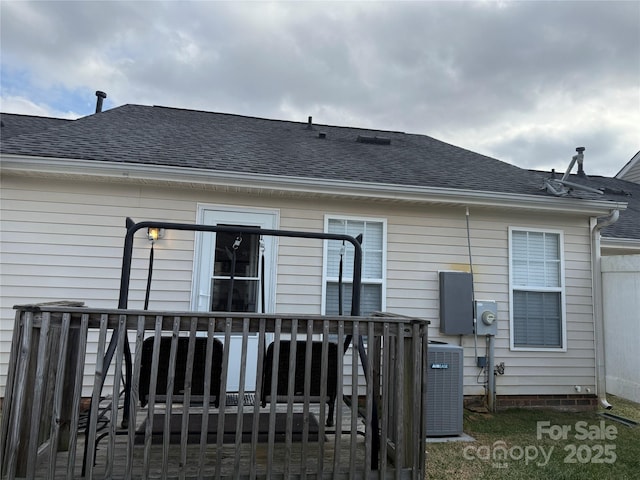 back of property with a wooden deck and central air condition unit