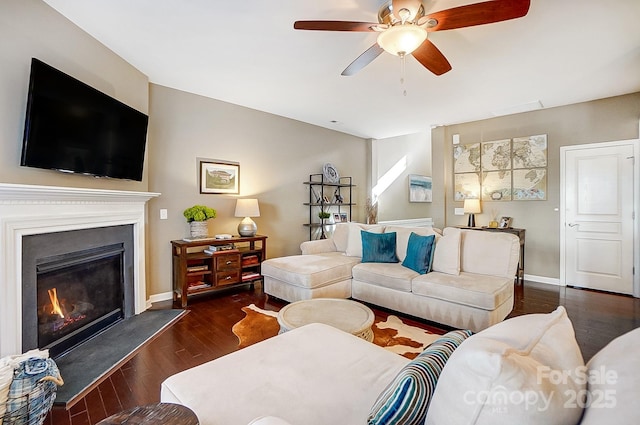 living room with ceiling fan and dark hardwood / wood-style flooring