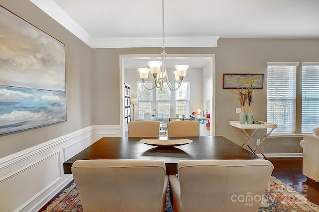 dining room featuring ornamental molding, dark wood-type flooring, and a chandelier