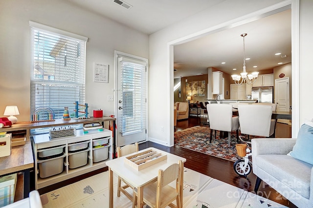 living room featuring hardwood / wood-style floors and a notable chandelier