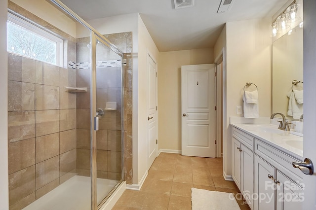 bathroom featuring vanity, tile patterned floors, and walk in shower