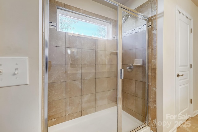 bathroom featuring a shower with door