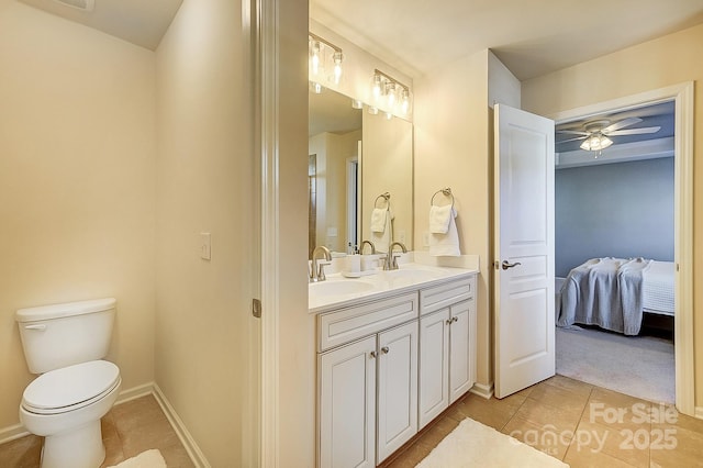 bathroom with ceiling fan, vanity, toilet, and tile patterned flooring