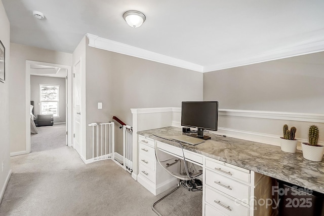 carpeted office space with crown molding