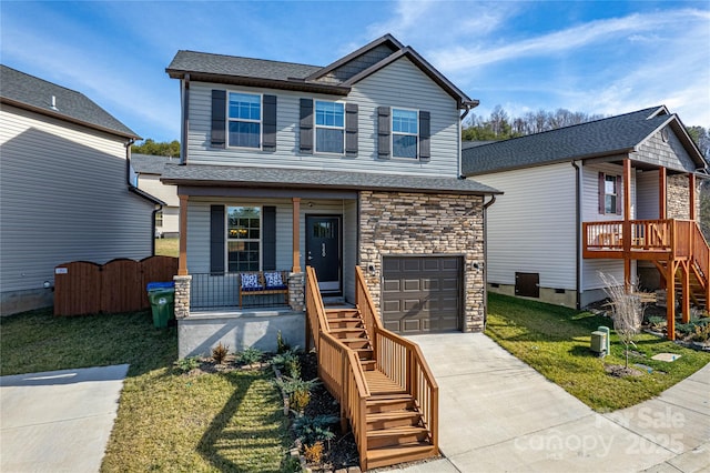 view of front of property with a garage, covered porch, and a front lawn