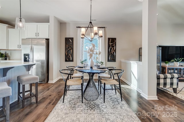 dining room with an inviting chandelier and dark hardwood / wood-style floors