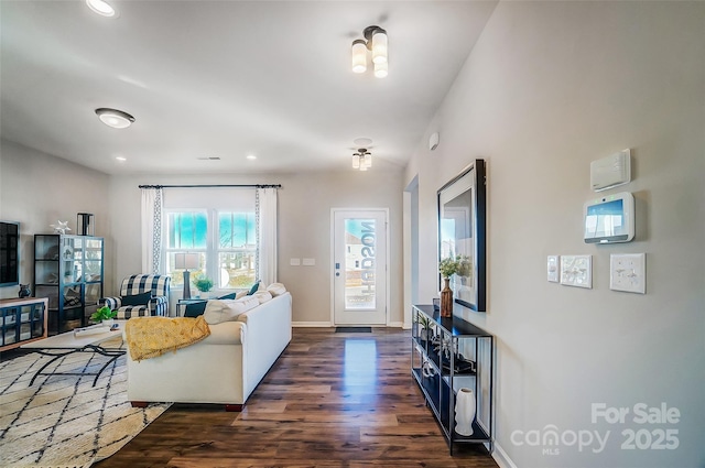 living room featuring dark wood-type flooring