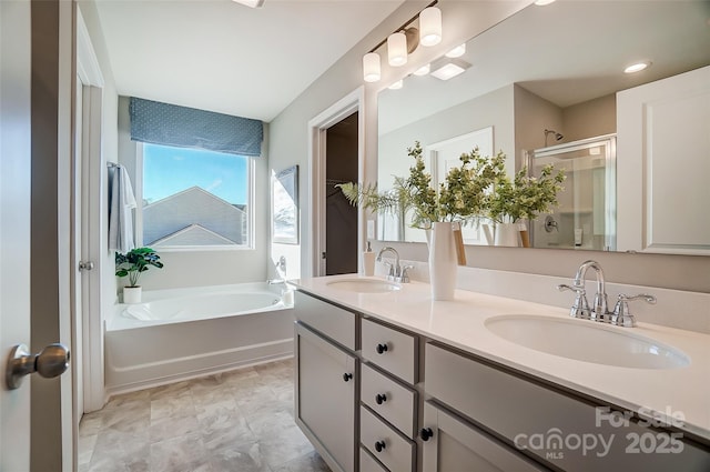 bathroom with vanity and independent shower and bath