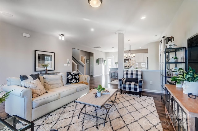 living room with recessed lighting, visible vents, dark wood-type flooring, baseboards, and stairs