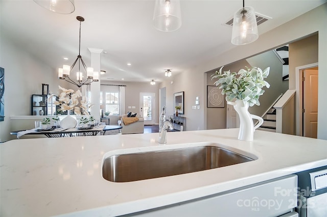 kitchen featuring a chandelier, hanging light fixtures, visible vents, and open floor plan