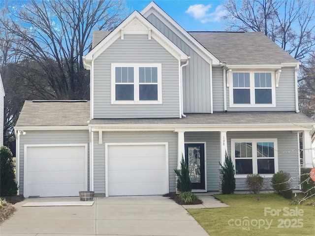 view of front of property featuring a shingled roof, board and batten siding, driveway, a porch, and a front yard