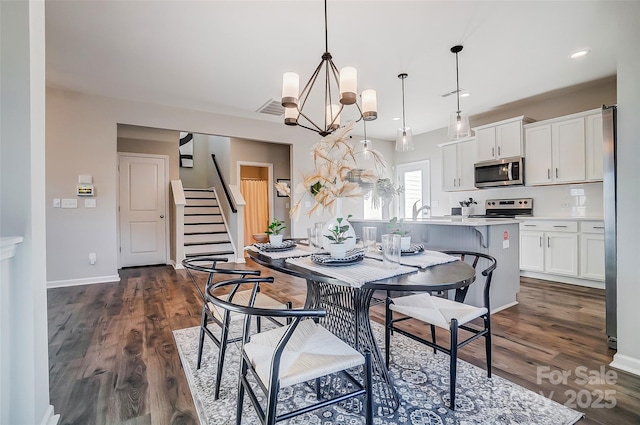 128 Shay Crossing Rd, Salisbury, NC 28146 - dining room featuring stairs, dark wood finished floors, a chandelier, baseboards, and recessed lighting