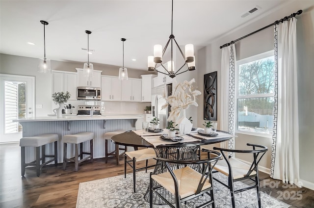 128 Shay Crossing Rd, Salisbury, NC 28146 - dining space featuring healthy amount of natural light, dark wood finished floors, a chandelier, and recessed lighting