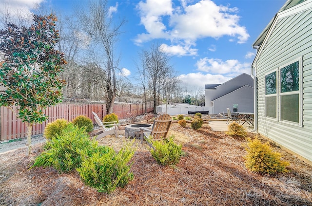 128 Shay Crossing Rd, Salisbury, NC 28146 - fenced backyard with a fire pit and a patio area