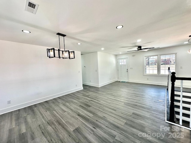 empty room featuring ceiling fan and dark hardwood / wood-style flooring