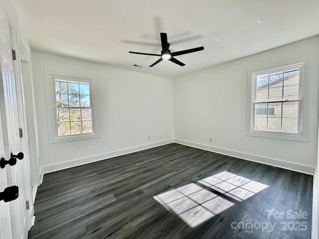 spare room featuring dark hardwood / wood-style floors and ceiling fan