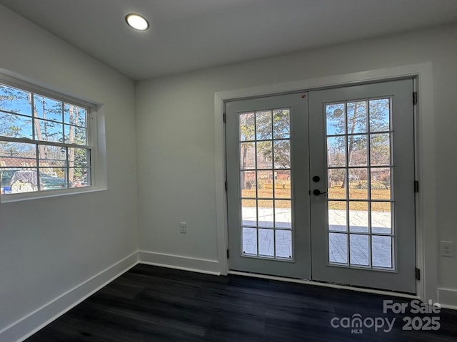 entryway featuring dark hardwood / wood-style floors and french doors