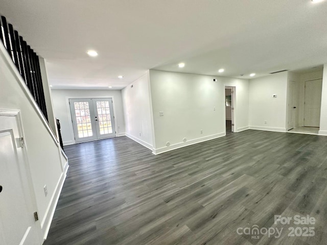 unfurnished living room featuring dark wood-type flooring and french doors