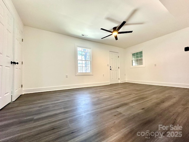 empty room featuring dark hardwood / wood-style floors and ceiling fan