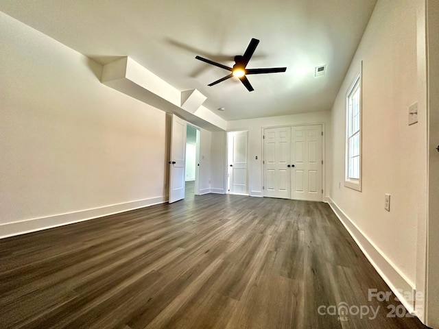 interior space featuring ceiling fan and dark hardwood / wood-style floors