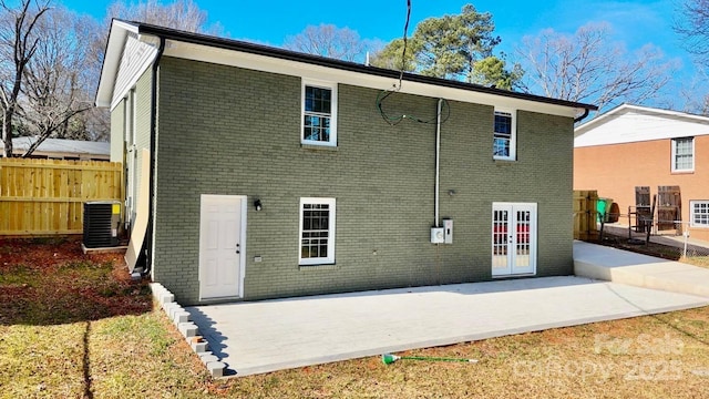 rear view of property with a patio, cooling unit, and french doors