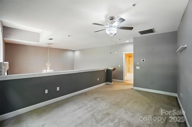 128 Steinbeck Way Unit E, Mooresville, NC 28117 - empty room featuring light colored carpet, baseboards, visible vents, and ceiling fan with notable chandelier
