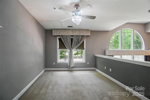 128 Steinbeck Way Unit E, Mooresville, NC 28117 - unfurnished room with baseboards, a ceiling fan, and a wealth of natural light