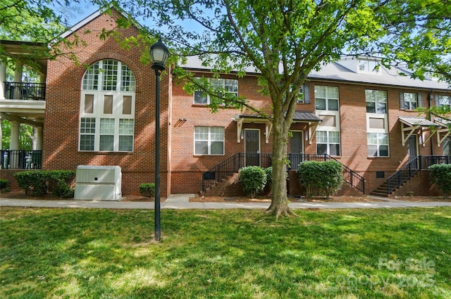 128 Steinbeck Way Unit E, Mooresville, NC 28117 - view of property with brick siding, a front lawn, and stairway