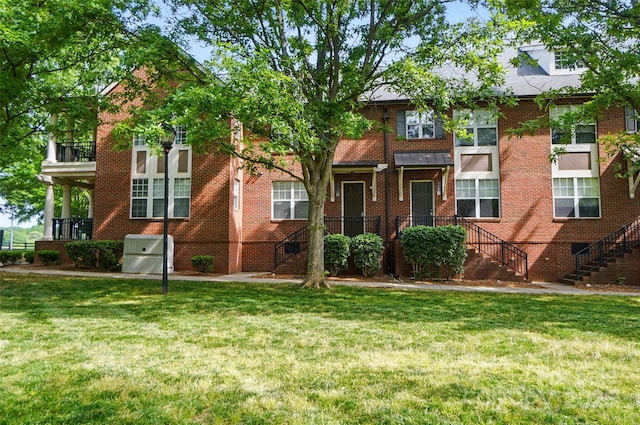 128 Steinbeck Way Unit E, Mooresville, NC 28117 - townhome / multi-family property featuring stairs, a front lawn, and brick siding