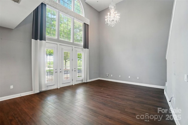 128 Steinbeck Way Unit E, Mooresville, NC 28117 - interior space with an inviting chandelier, dark wood-type flooring, baseboards, and a towering ceiling