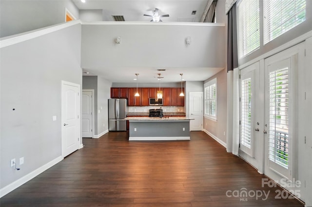 128 Steinbeck Way Unit E, Mooresville, NC 28117 - kitchen with a ceiling fan, a towering ceiling, light countertops, stainless steel appliances, and dark wood-type flooring