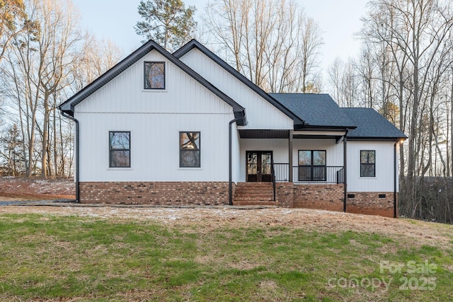 modern farmhouse with covered porch, a shingled roof, crawl space, and brick siding