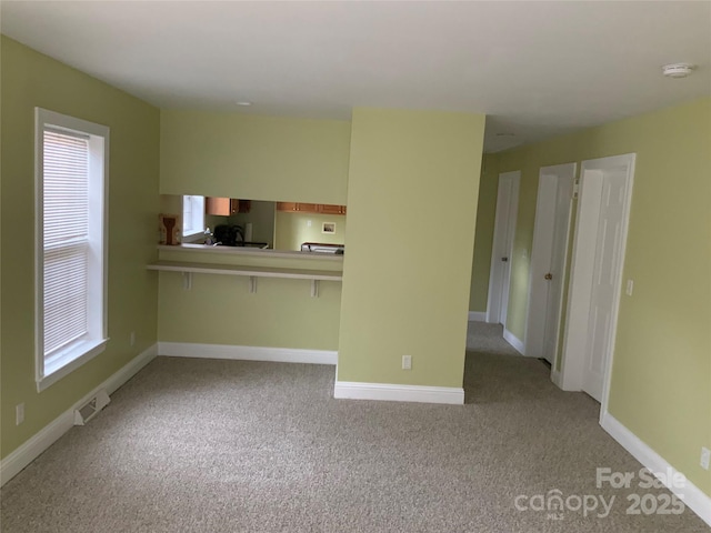 7 Chapel Park Pl, Asheville, NC 28803 - unfurnished living room featuring light carpet