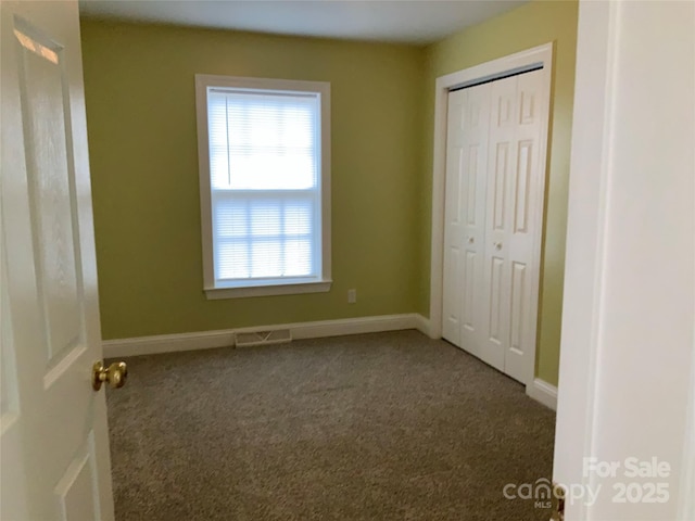 7 Chapel Park Pl, Asheville, NC 28803 - unfurnished bedroom featuring a closet and carpet