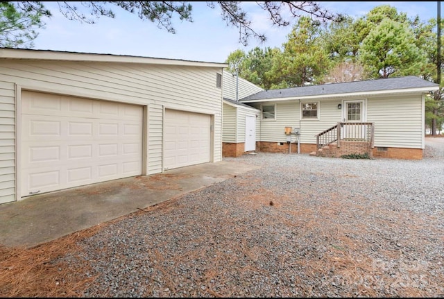 rear view of house featuring a garage