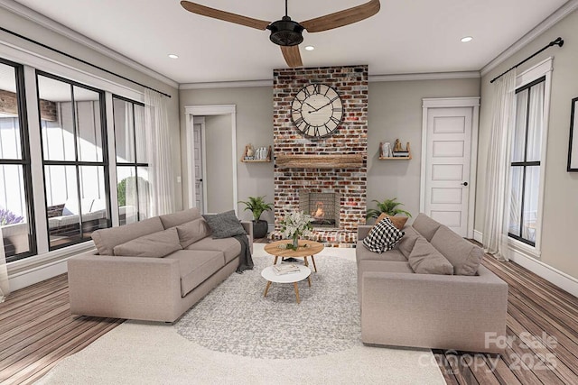 living room with recessed lighting, ornamental molding, a ceiling fan, a brick fireplace, and baseboards