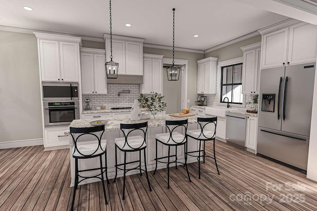 kitchen featuring a kitchen bar, appliances with stainless steel finishes, a sink, and ornamental molding