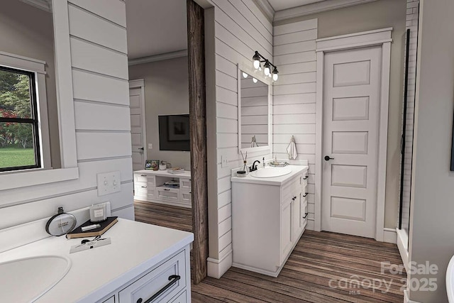 bathroom featuring wood walls, crown molding, wood finished floors, and vanity