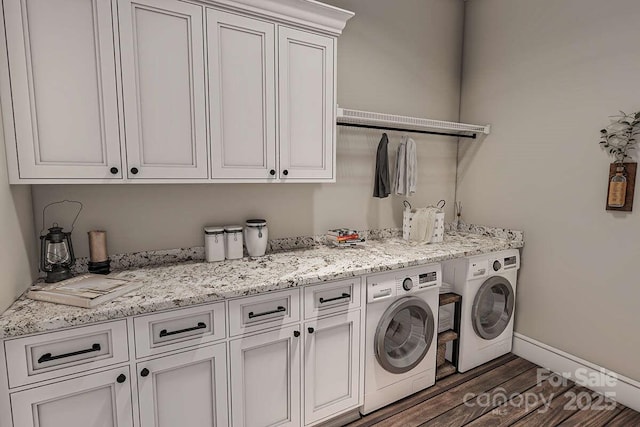 washroom featuring baseboards, dark wood-type flooring, cabinet space, and washer and dryer