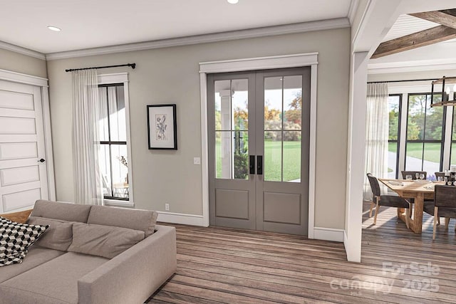 interior space with ornamental molding, wood finished floors, a wealth of natural light, and french doors