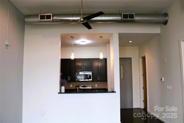 kitchen with pendant lighting, ceiling fan, stainless steel appliances, decorative backsplash, and kitchen peninsula