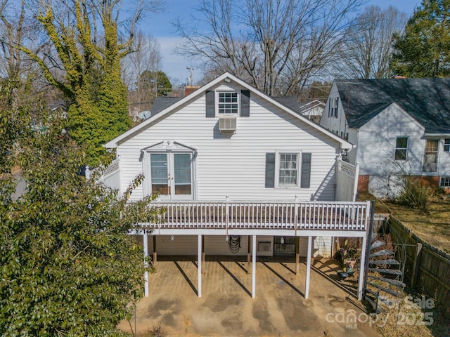 rear view of house featuring a deck and a patio area